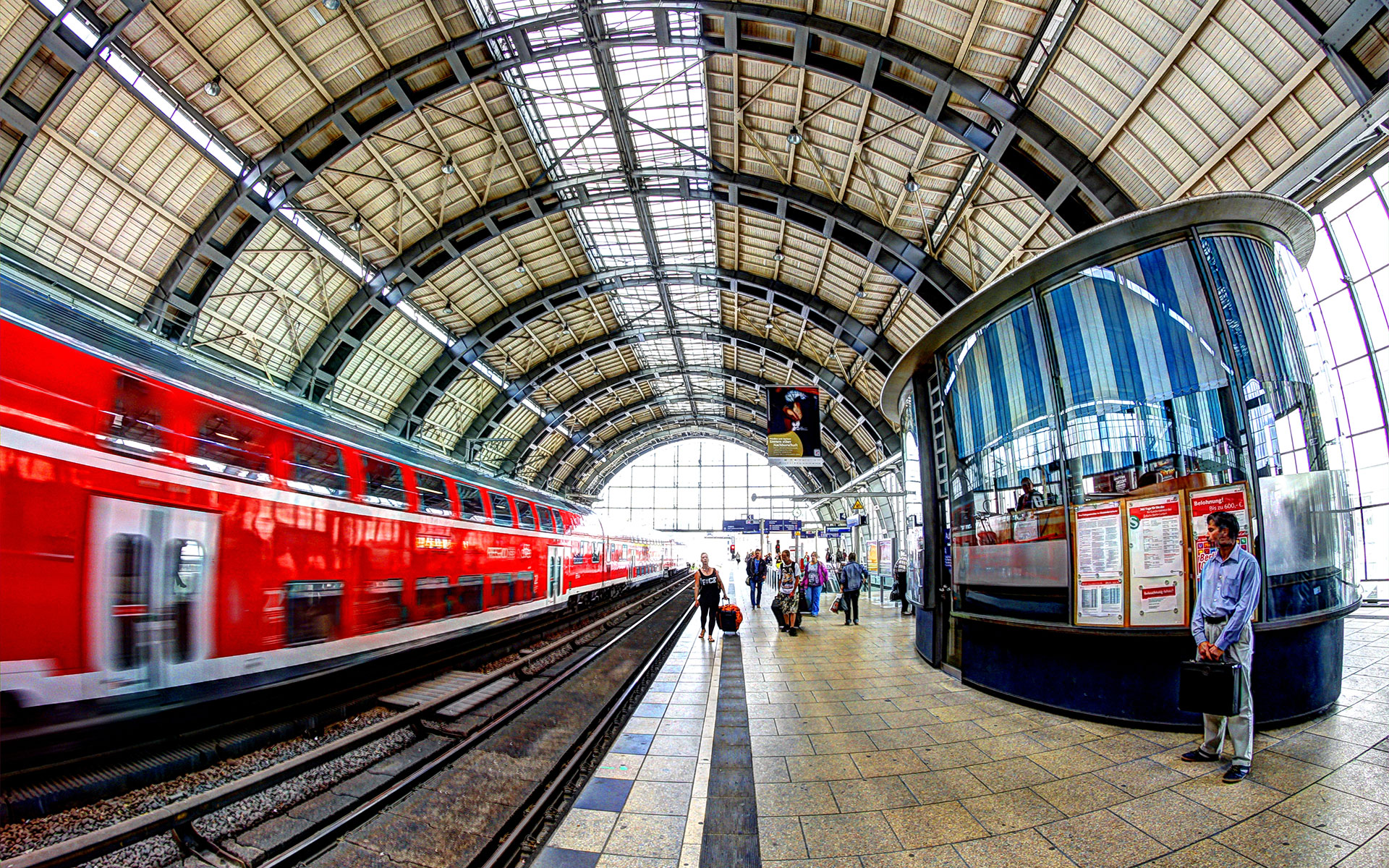 One of Deutsche Bahn’s red regional double-deck trains dashing through a Berlin station (photo © Andrea Calistri).